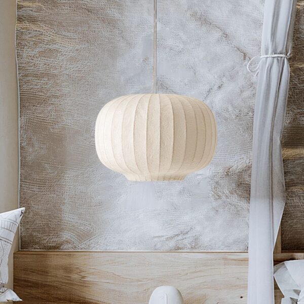 Cream pleated lantern pendant light hanging in a bedroom