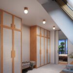 Three small wooden ceiling spotlights with exposed bulbs above a wardrobe hallway with a bench