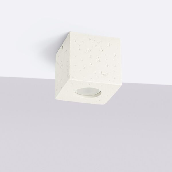 Cubic ceiling light in beige textured concrete with a round light opening