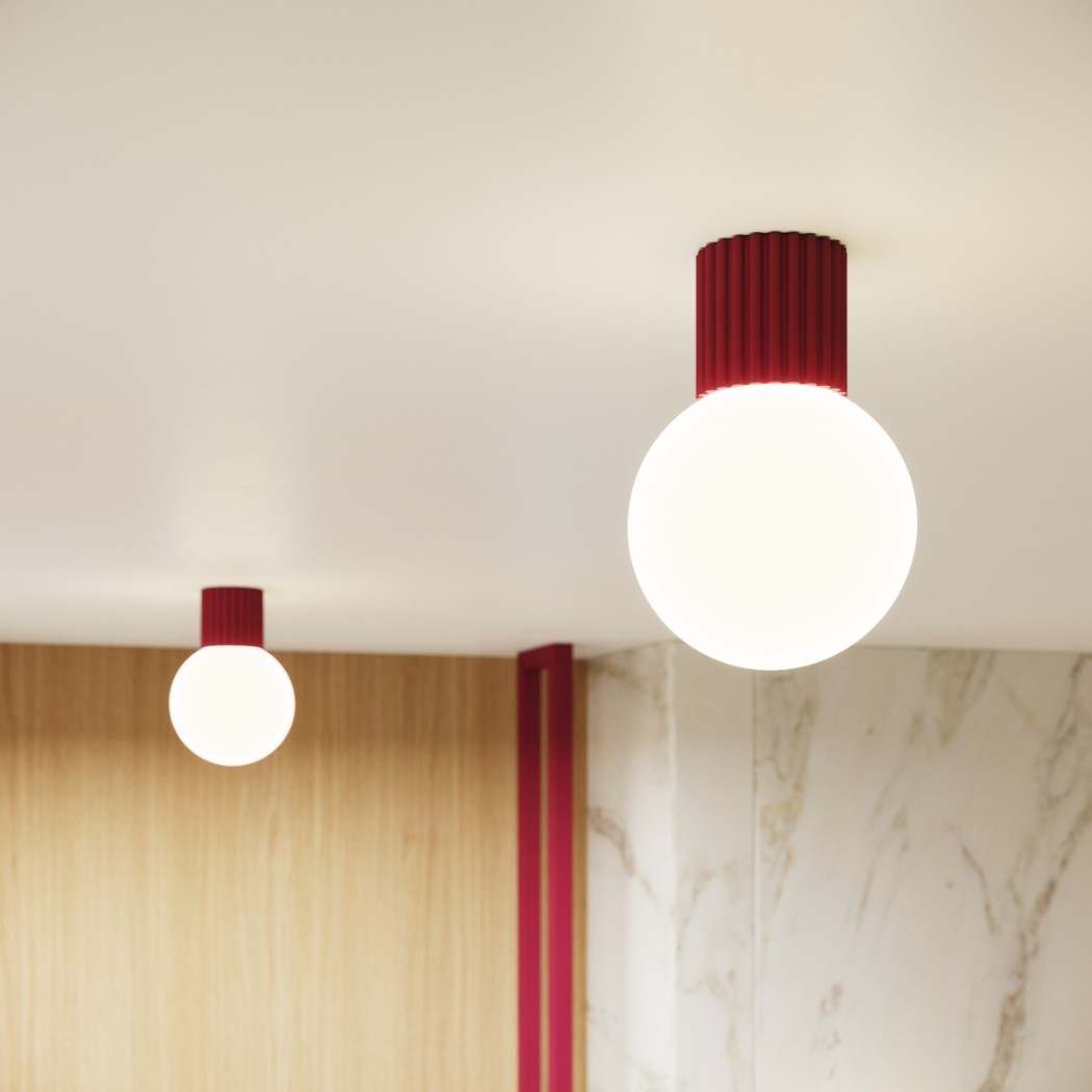 Two burgundy ribbed ceiling lights with opal globes of different sizes matching the wall trim