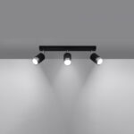 Black three-spot track ceiling light with all lights glowing downward