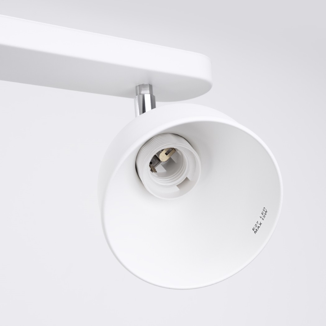 Close-up of the white cylindrical head of an unlit ceiling spotlight