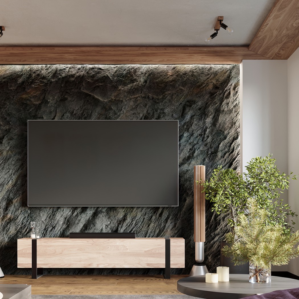 Adjustable ceiling spotlights above a marble accent wall with a TV