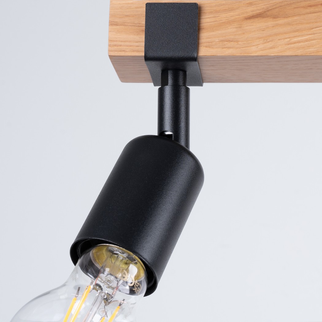 Close-up of a black adjustable spotlight head with a visible bulb