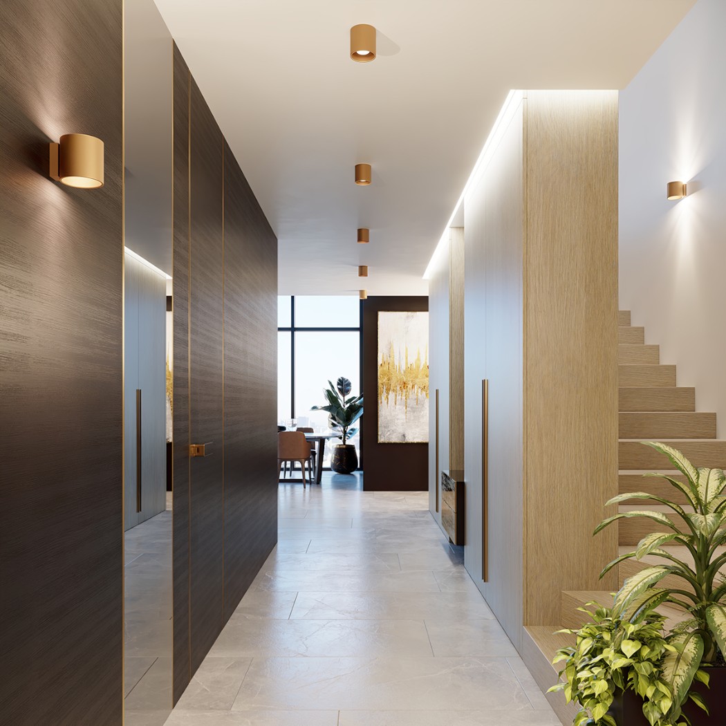 Row of gold cylindrical spotlights lighting a hallway beside dark wood doors