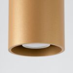 Close-up of the brushed gold cylindrical spotlight's white lens