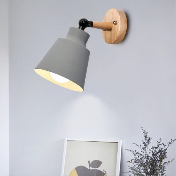 Grey cone-shaped wall light on a round wood mounting disc with an angled arm