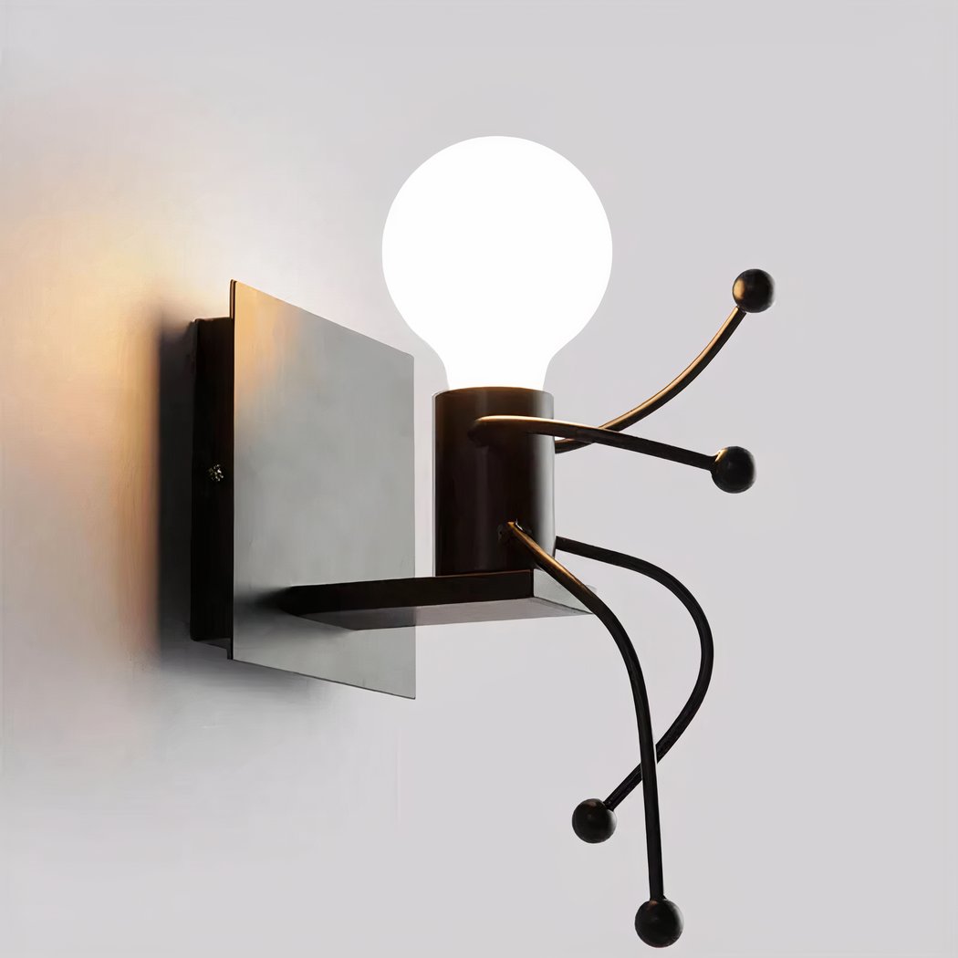 Black wall light shaped like a stick figure holding a round bulb head