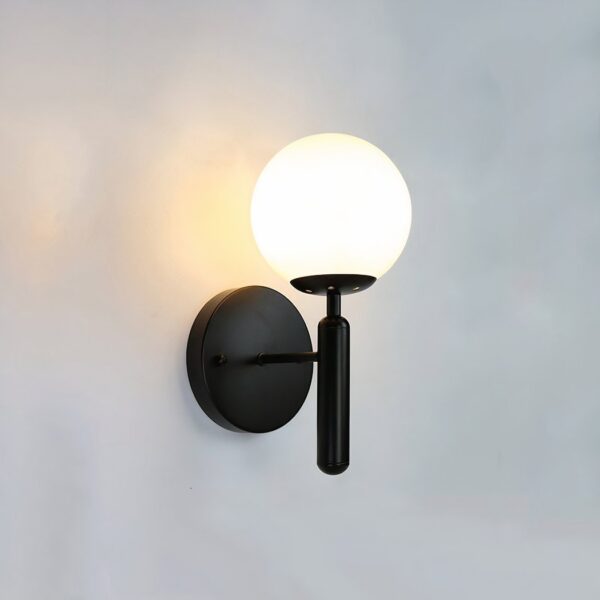 Black wall light with a round opal glass globe on a slim vertical stem