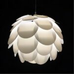 White pinecone-shaped layered petal pendant light against a dark background