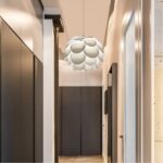 White layered petal-shaped pendant light hanging in a dark hallway