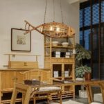 Wooden fish-shaped pendant light beside a wooden display shelf