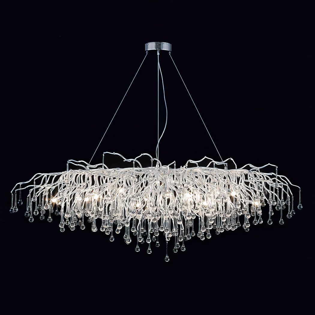 Large gold chandelier with cascading crystal teardrops on wavy branches against black