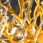 Close-up of gold branches and hanging crystal teardrops on the chandelier