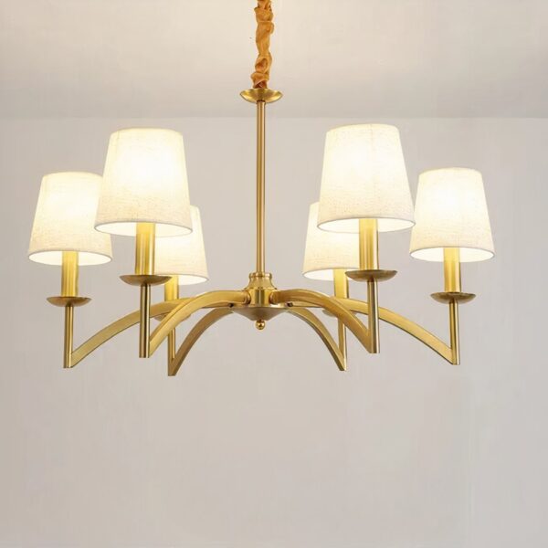 Gold six-arm chandelier fitted with white fabric drum shades