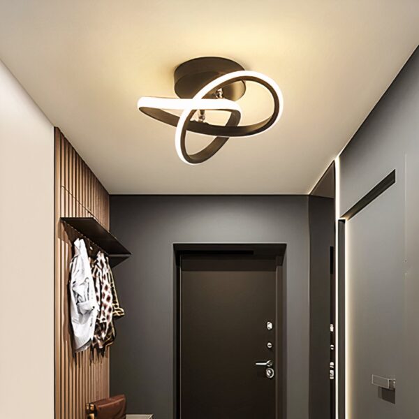 Black looped ribbon-shaped LED ceiling light in a hallway