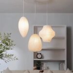 Three white paper lantern pendant lights in different organic shapes