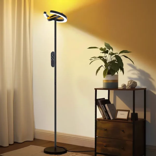 Black floor lamp with two adjustable ring shaped LED heads in a corner