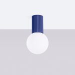 Blue fluted cylindrical ceiling fitting topped with a round white glass globe