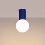 Blue fluted cylinder ceiling light with a round white glass globe below