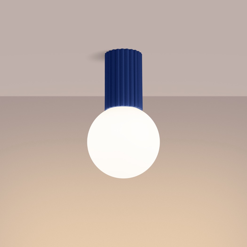 Blue fluted cylinder ceiling light with a round white glass globe below