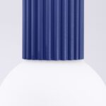 Close-up of the blue fluted cylinder joining the white glass globe