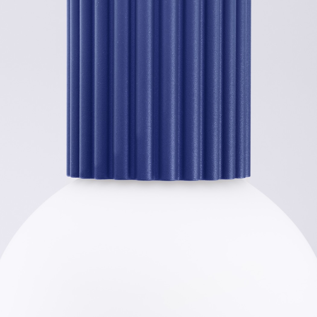 Close-up of the blue fluted cylinder joining the white glass globe
