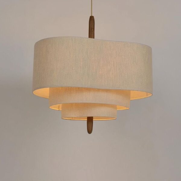 Tiered pendant light with a beige fabric drum shade
